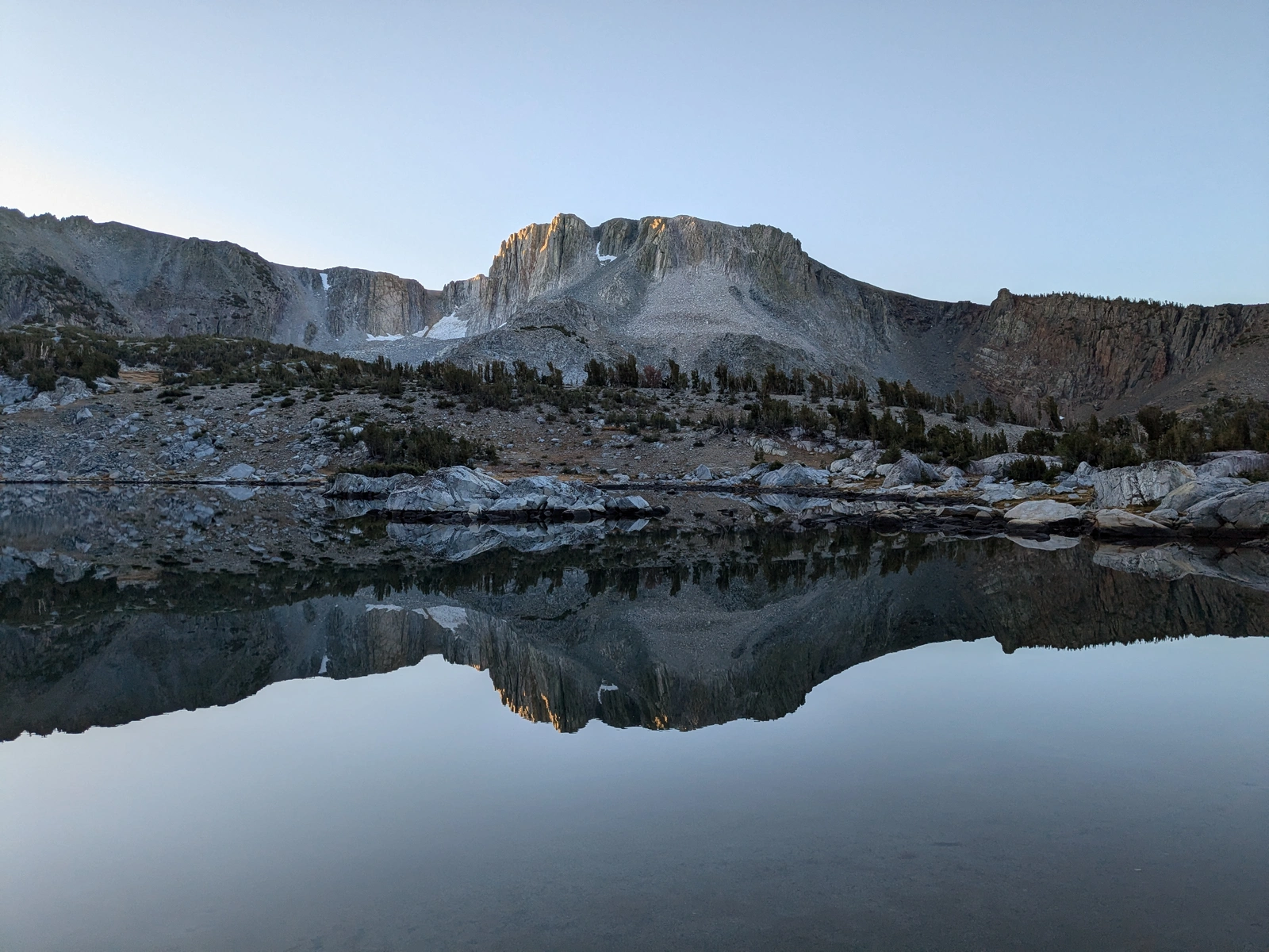 Sunlight dusting Peak 11627 over our mirror-smooth lake