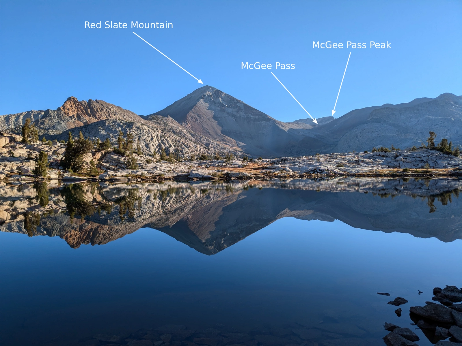 Red Slate Mountain dominates the horizon, reflected serenely in Cotton Lake