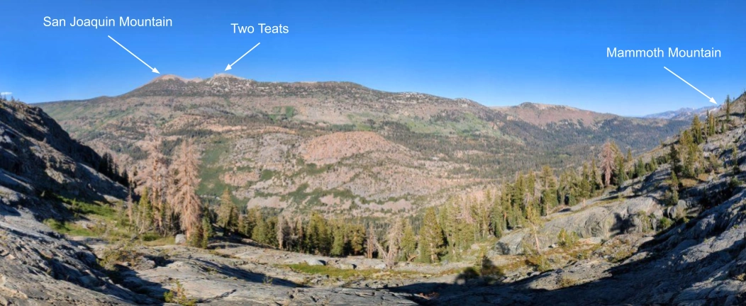 To the east, the valley dropped down below. The PCT runs along the opposite side. Mammoth even peeked out to the south.