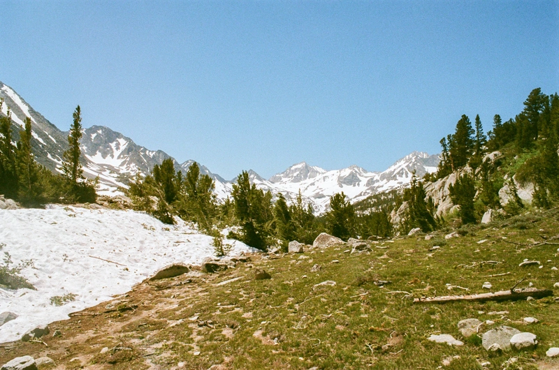 The Bear Creek Spire group, shrouded in snow, comes into view